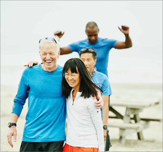 Group of older friends embracing after early morning workout.