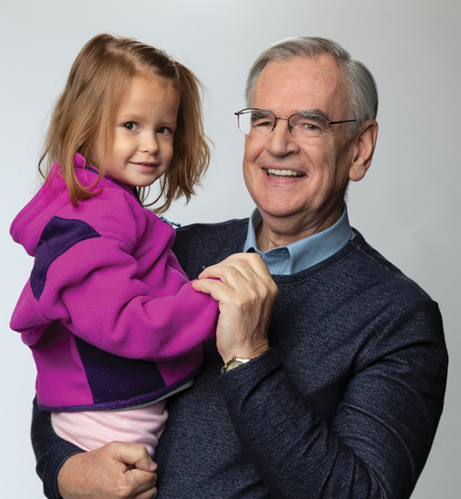 Grandfather holding his granddaughter.