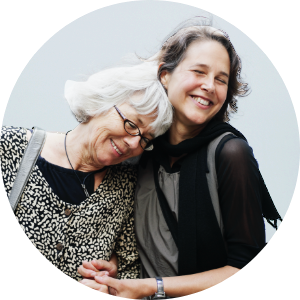 Older mother with daughter embracing.