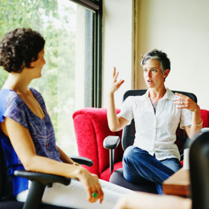 Two women talking in an office.